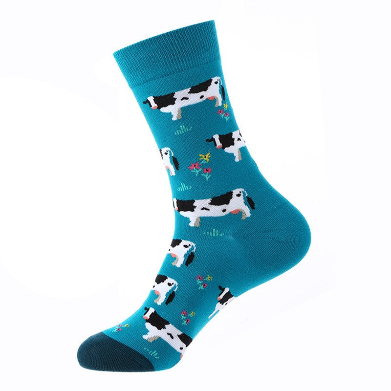 Teal crew sock with black-and-white cows and small flowers, dark-teal toe — animal themed