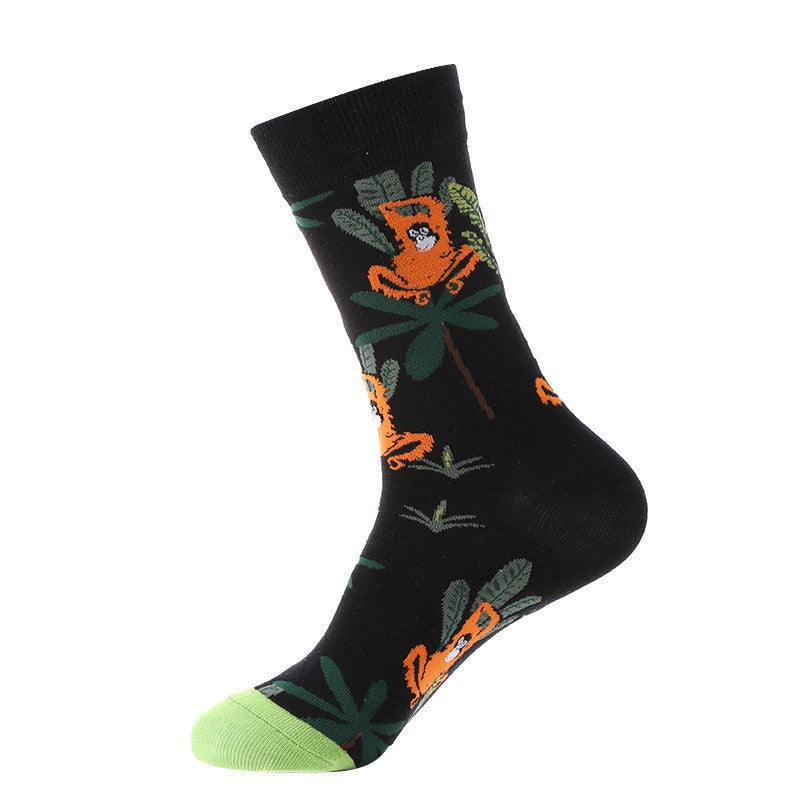 Black crew sock with orange monkeys and jungle leaves, green toe — animal themed
