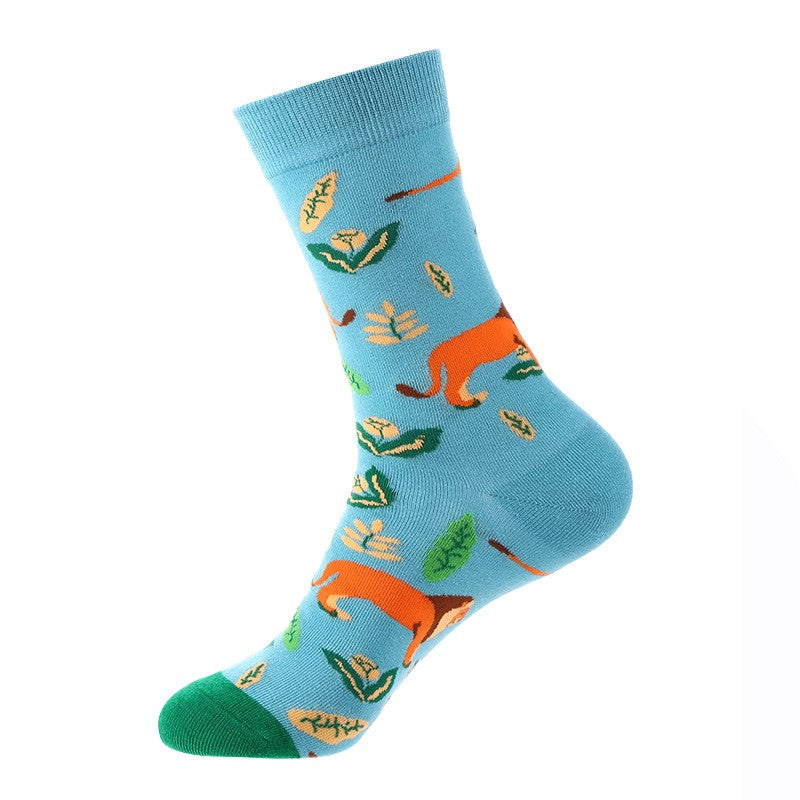 Light blue crew sock with orange foxes and green leaves, green toe — animal themed